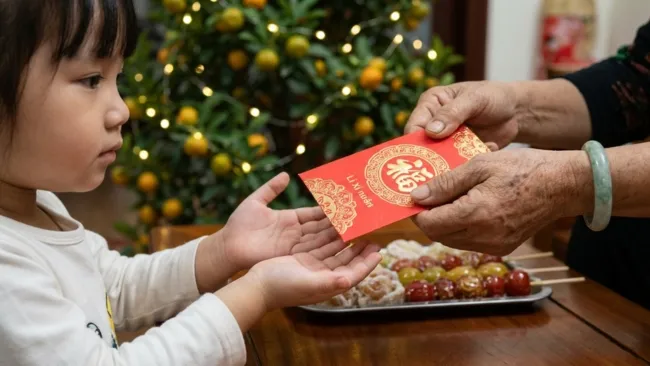 Dạy trẻ nhận lì xì bằng hai tay lễ phép