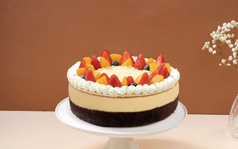 Bánh flan gato với nhiều loại trái cây tươi và pin trang trí